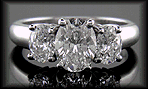Three stone platinum engagement rings with three oval diamonds.