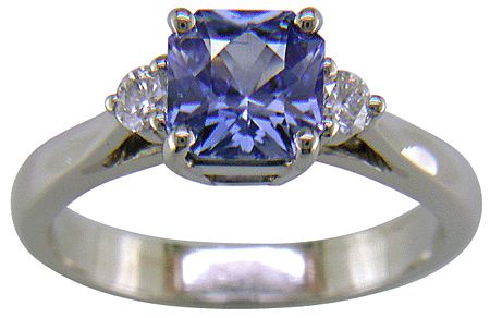 Radiant-cut sapphire set with two round diamonds in a handcrafted platinum ring. (J8522)