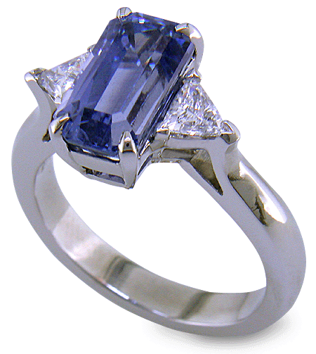 A handcrafted platinum ring with a emerald-cut pastel Sapphire and sparkling diamonds. (J8541)