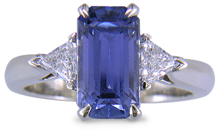 A handcrafted platinum ring with a emerald-cut pastel Sapphire and sparkling diamonds. (J8541)