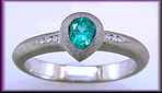 Pear-shape Paraiba tourmaline accented with diamonds in a custom platinum ring.