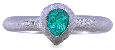 Pear-shape Paraiba tourmaline accented with diamonds in a custom platinum ring.