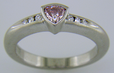 Side view of trilliant pink diamond custom platinum ring.