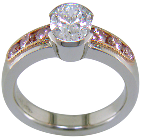 Oval Diamond set with 6 brilliant Pink Diamonds in a custom rose gold and platinum ring.