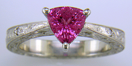 Hand engraved platinum ring with a trillium pink sapphire.