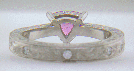 Inside view of hand engraved platinum ring with a trillium pink sapphire.