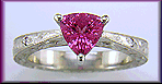 Hand engraved platinum ring with a trillium pink sapphire.