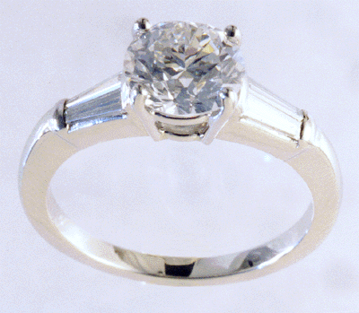 Platinum engagement ring with tapered baguette diamonds.