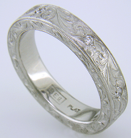 Hand engraved platinum band set with diamonds.