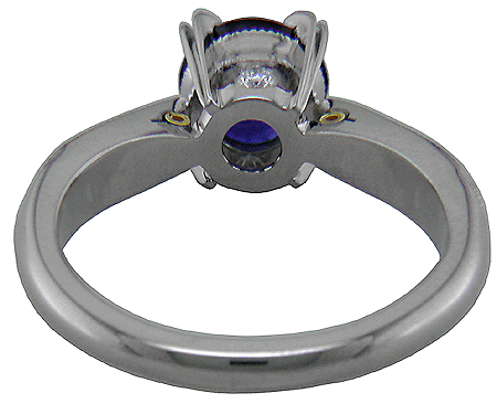 Inside view of sapphire ring with two hidden diamonds and 18kt gold accents.