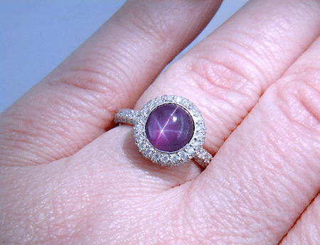 Plum Star Sapphire set with pave diamonds in a platinum ring.