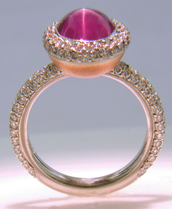 Side view of Plum Star Sapphire and pave diamond platinum ring.