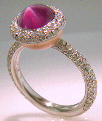 Plum Star Sapphire set with pave diamonds in a platinum ring.