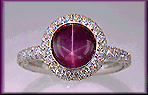 Plum Star Sapphire set with pave diamonds in a platinum ring.