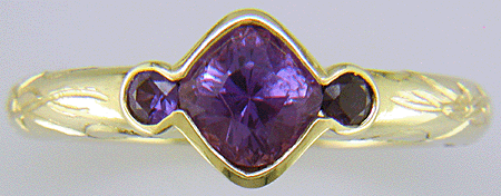 Cushion-cut Purple Sapphire with round Purple Sapphires in a custom platinum ring. (J8546)