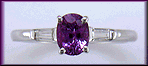 An oval Purple Sapphire set with tapered baguette diamonds in a custom platinum ring.
