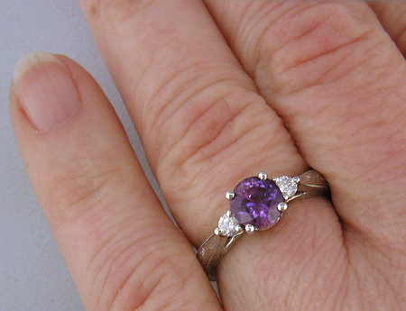 Purple Sapphire set with two round diamonds in a hand-engraved platinum ring. (J8525)