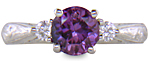 Purple Sapphire set with two round diamonds in a hand-engraved platinum ring.