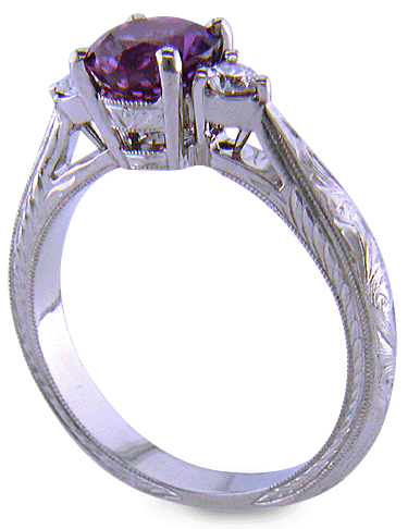 Side view of Purple Sapphire set with two round diamonds in a hand-engraved platinum ring. (J8525)