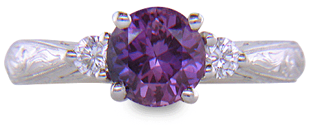 Purple Sapphire set with two round diamonds in a hand-engraved platinum ring. (J8525)