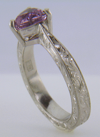 Hand engraved platinum ring with a trillium Purple Sapphire.
