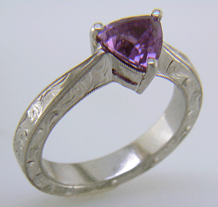 Hand engraved platinum ring with a trillium Purple Sapphire.