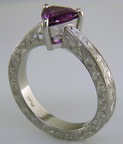 Hand engraved platinum ring with a trillium purple sapphire.
