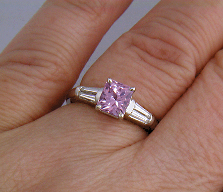 A radiant Pink Spinel set with tapered baguette diamonds in a custom platinum ring.