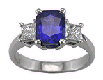 Radiant-cut sapphire and two princess-cut diamonds in a stiking platinum ring.