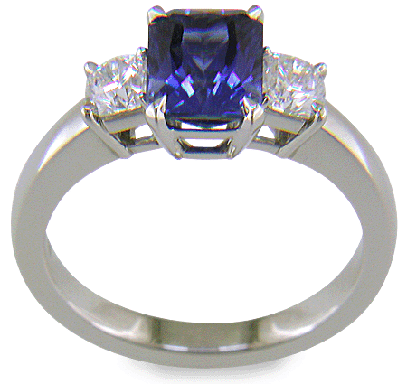 A handcrafted platinum ring with a sriking Radiant-cut Sapphire and two sparkling Flanders-cut diamonds. (J8595)