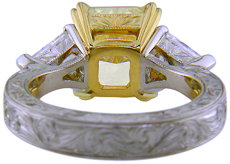 Inside view of engraved custom ring with a yellow radiant-cut diamond and trilliants.