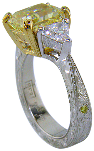 Yellow radiant-cut diamond with trilliant diamonds in a custom platinum ring.