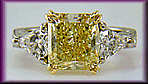 Yellow radiant-cut diamond with kite-shape diamonds in a custom platinum ring.