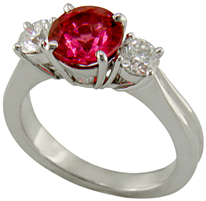 Red spinel ring with side diamonds.