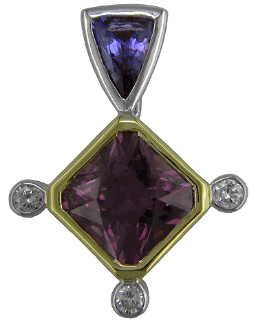18kt gold and platinum pendant with a garnet, sapphire and diamonds.