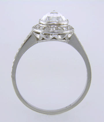 Side view of Rose-cut diamond set in a platinum ring accented with small Rose-cut diamonds.