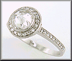 Rose-cut diamond set in a platinum ring accented with small Rose-cut diamonds.