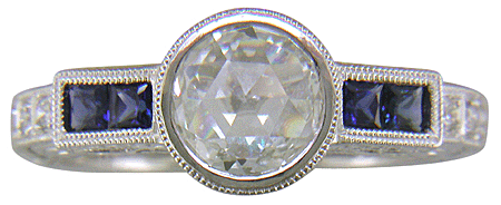 A Rose-cut Diamond set with Sapphires in a platinum ring.