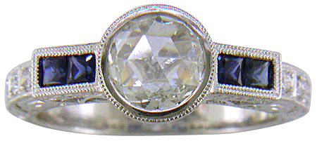 A Rose-cut Diamond set with Sapphires in a platinum ring. (J8749)
