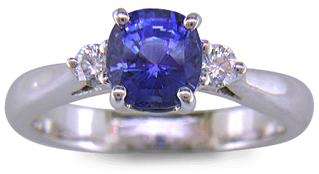 Cushion-cut sapphire set with two round diamonds in a handcrafted platinum ring. (J8598)