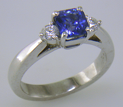Barion-cut sapphire set with two round diamonds in a handcrafted platinum ring.
