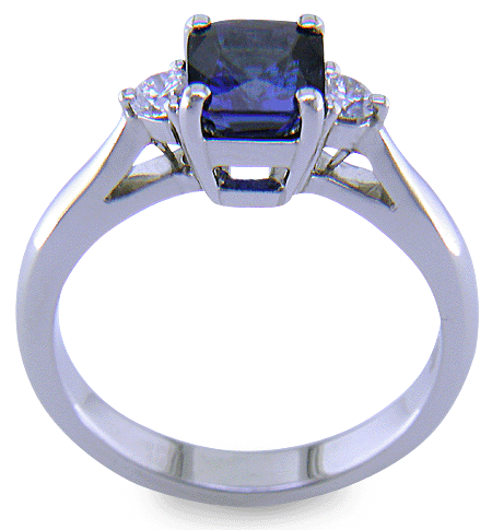 Emerald-cut sapphire set with two round diamonds in a handcrafted platinum ring. (J8540)