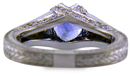 Inside view of bright sapphire set with 42 accenting diamonds in an engraved platinum ring. (J6410)
