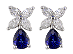 A striking pair of diamond earrings with sapphire drops set in platinum.