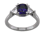 Cushion-cut sapphire and trilliant diamonds in a platinum ring.