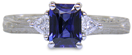 Sapphire ring with trilliant diamond and hand engraved platinum. (J8423)