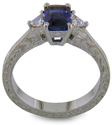Side view of hand-engraved platinum ring with radiant-cut sapphire and diamonds.