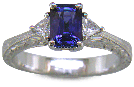 Sapphire ring with trilliant diamond and hand engraved platinum.