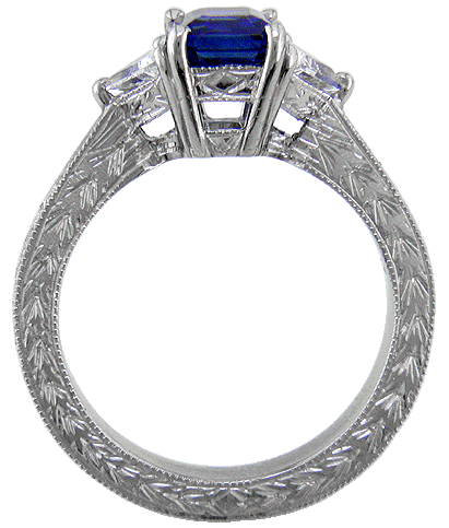 Side view of hand-engraved platinum ring with sapphire and diamonds.