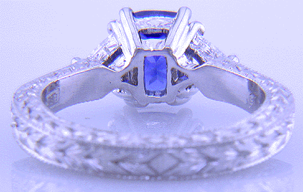 Inside view of platinum hand-engraved ring with cushion sapphire and diamonds.